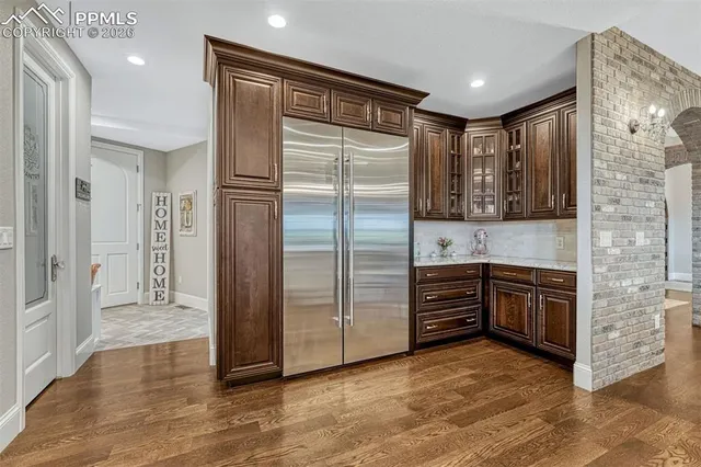 a kitchen with stainless steel appliances granite countertop a refrigerator and a stove top oven