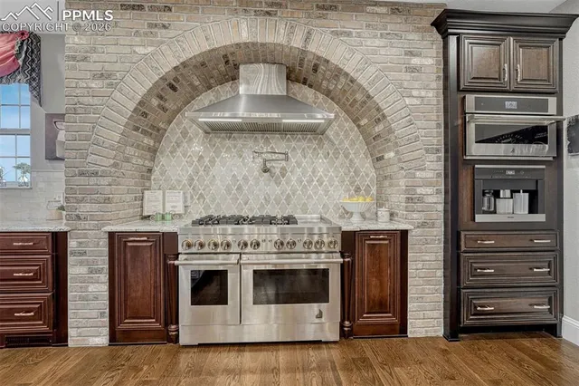 a stove top oven sitting inside of a kitchen