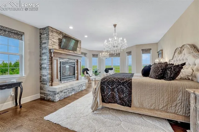 a living room with furniture a fireplace and a chandelier