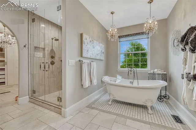 a spacious bathroom with a shower and a sink a mirror