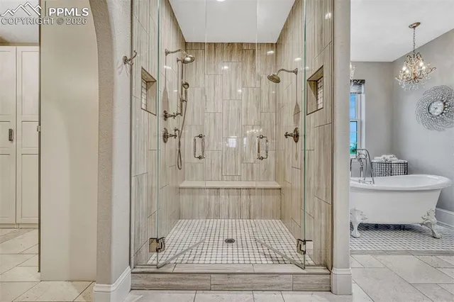 a bathroom with a glass shower door and a window