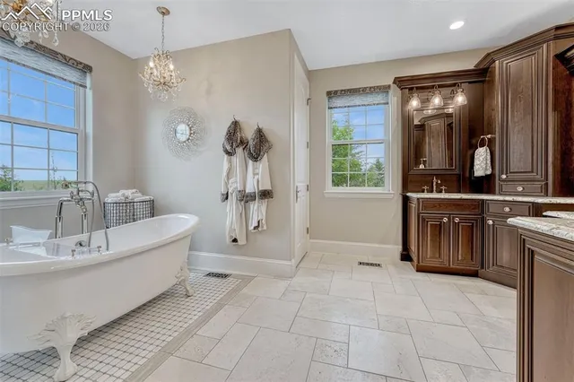 a spacious bathroom with a tub sink and mirror