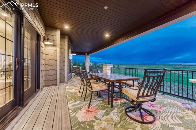 a patio with glass top table and chairs