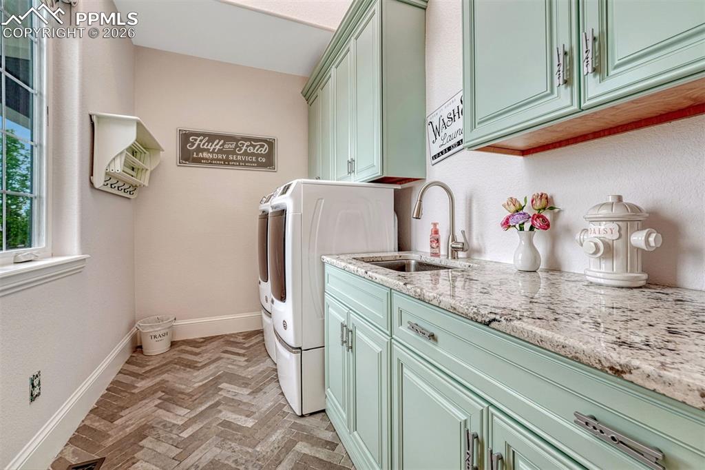 25995 Cave Spg Trail Elbert, CO 80106 - Photo 33 of 50 a bathroom with a sink and a washing machine