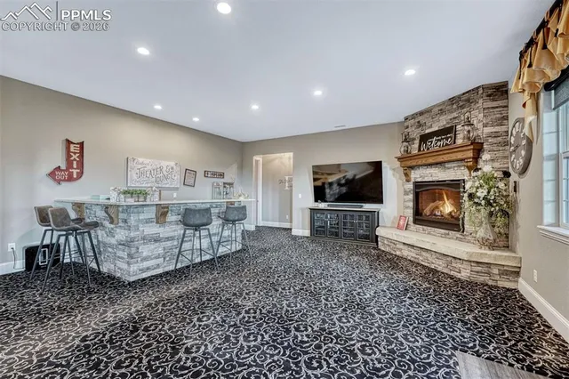 a living room with furniture a flat screen tv and a fireplace