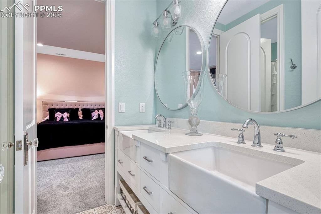 25995 Cave Spg Trail Elbert, CO 80106 - Photo 41 of 50 a en suite bathroom with a double vanity sink and mirror