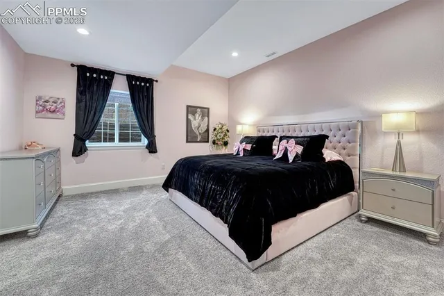 a bedroom with a large bed and a window