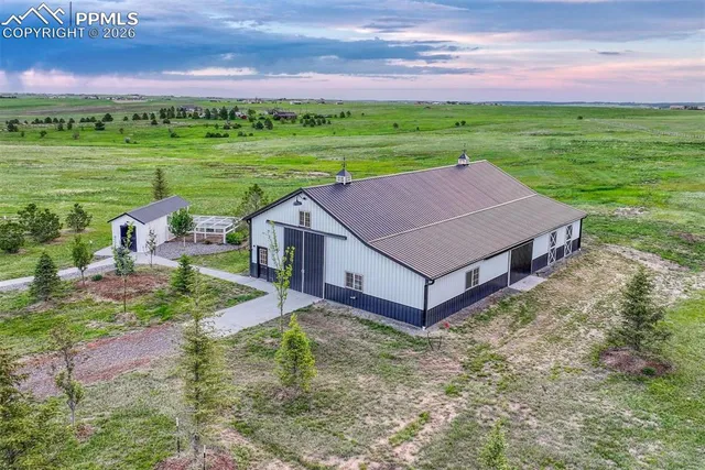 a view of a big house with a big yard