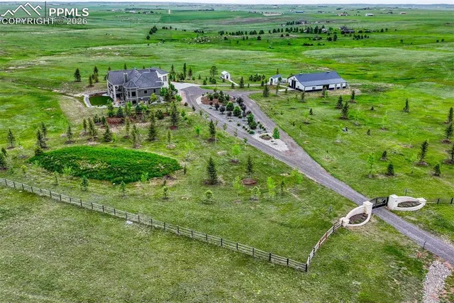 a backyard of a house with a yard and outdoor seating