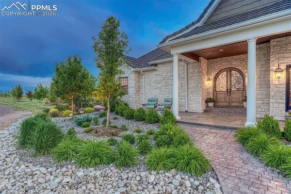 a front view of a house with garden