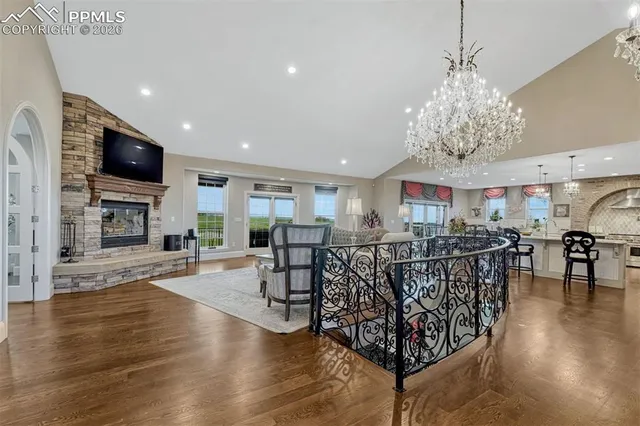 a view of a livingroom with furniture wooden floor and a chandelier