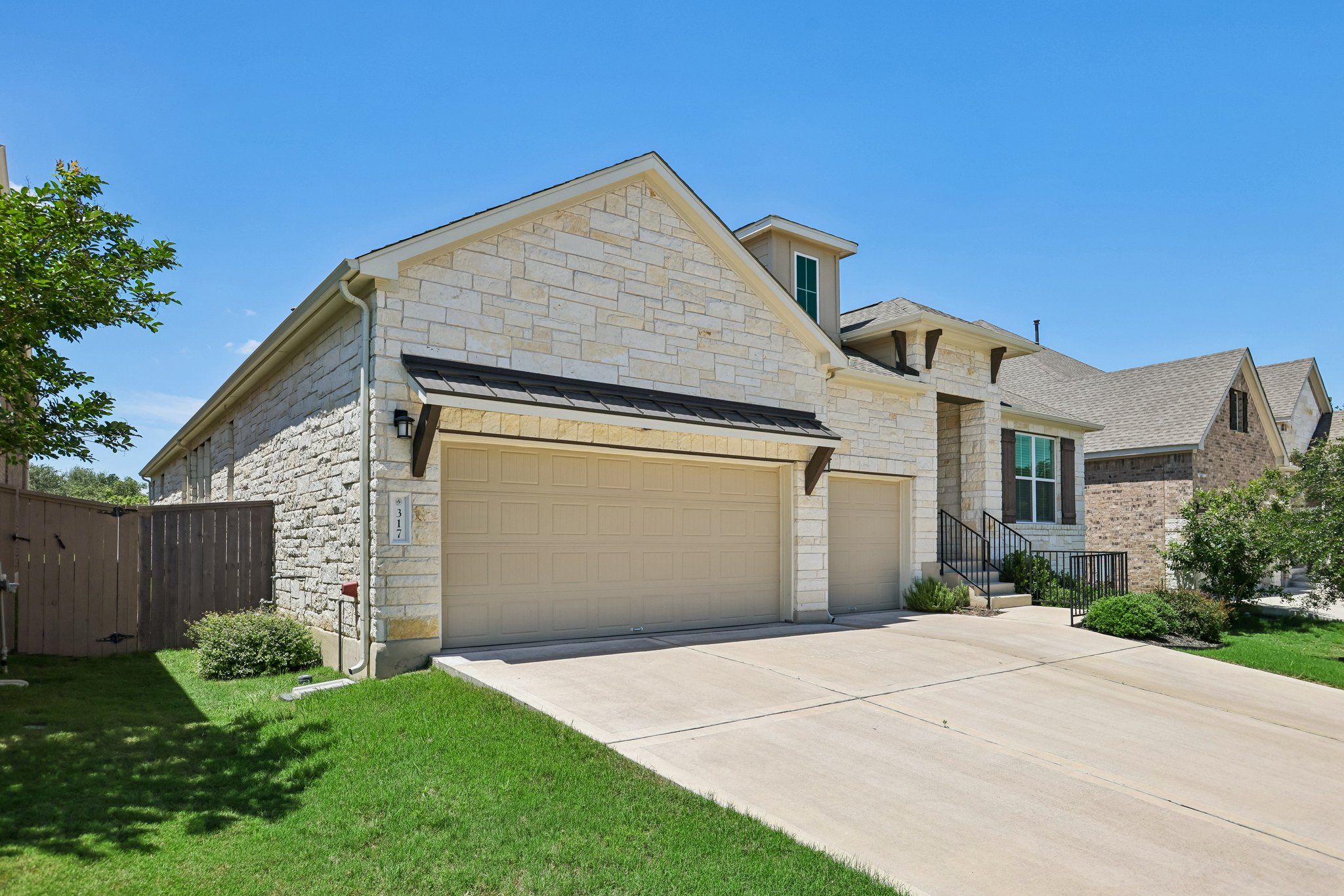 317 Independence Drive Kyle, TX 78640 - Photo 2 of 40 a front view of a house with a yard and garage