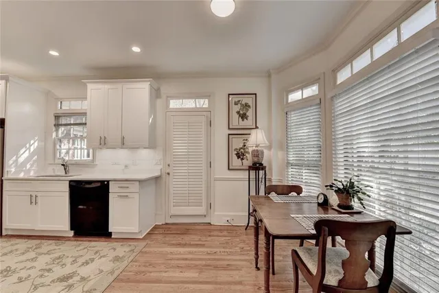 a kitchen with granite countertop a sink cabinets and wooden floor