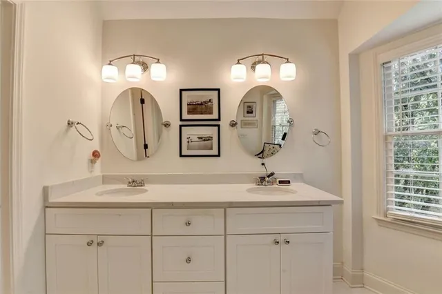 a bathroom with a double vanity sink and a mirror