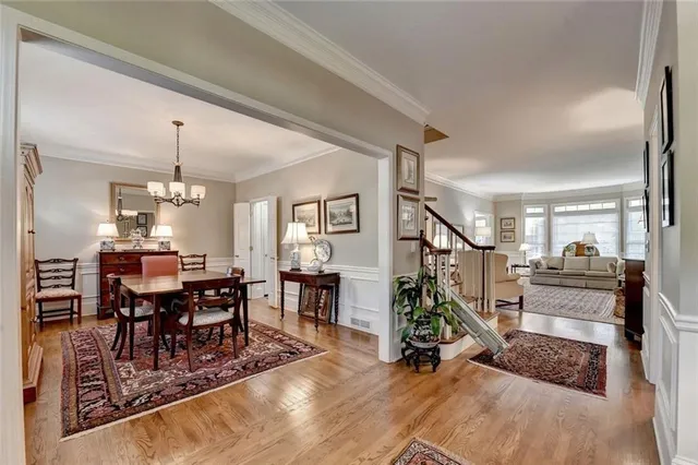 a view of a livingroom with furniture wooden floor and a chandelier