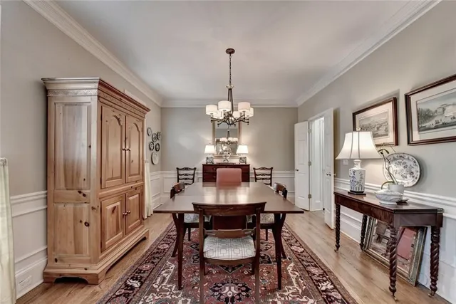 a dining room with furniture a chandelier and wooden floor