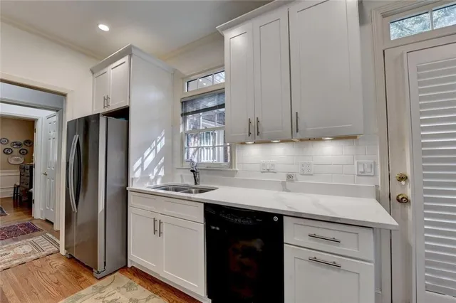 a kitchen with appliances cabinets and a sink