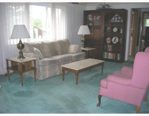 Living Room. The large 23 foot living room was originally designed as a living room dining room combination. There are hardwood floors under the carpeting and updated mechanicals.