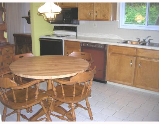 Kitchen. The large ceramic tile kitchen is fully-equipped with a range, dishwasher, refigerator, and microwave