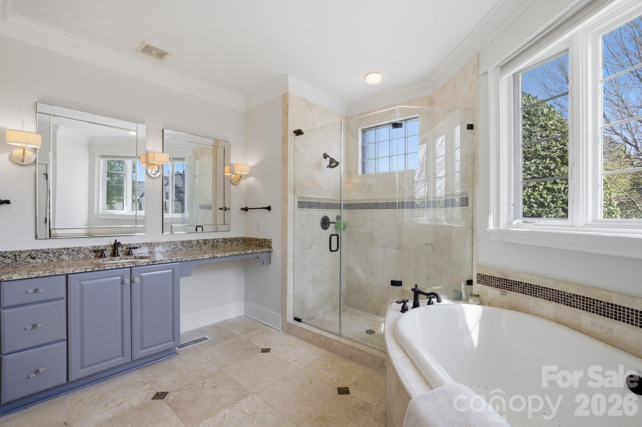 17335 Players Ridge Drive Cornelius, NC 28031 - Photo 16 of 27 a spacious bathroom with a granite countertop tub sink shower and mirror