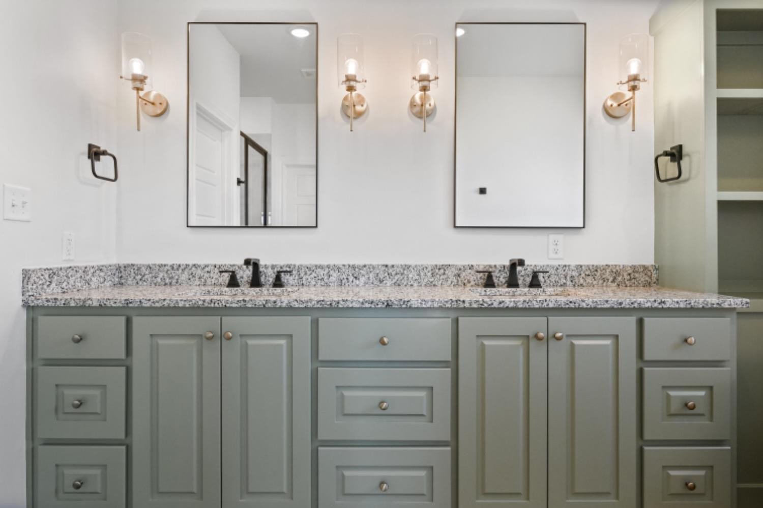 5607 119th Street Lubbock, TX 79424 - Photo 20 of 33 a bathroom with a granite countertop sink vanity and mirror