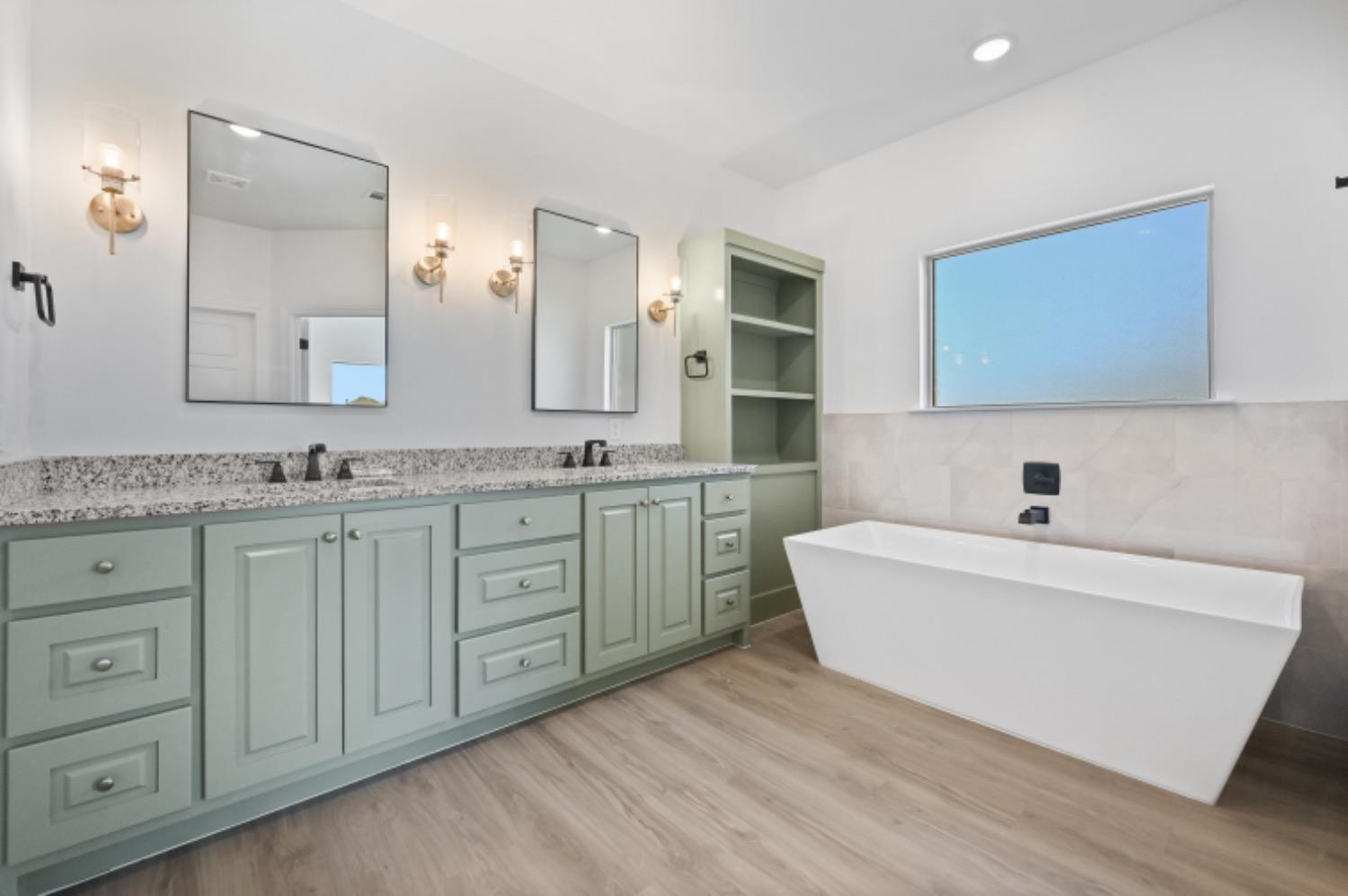 5607 119th Street Lubbock, TX 79424 - Photo 23 of 33 a bathroom with a granite countertop sink mirror and bathtub