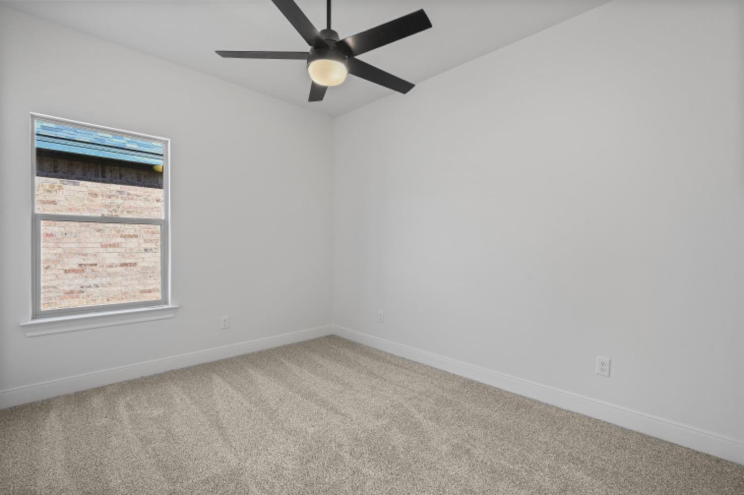 5607 119th Street Lubbock, TX 79424 - Photo 26 of 33 an empty room with a window and a fan