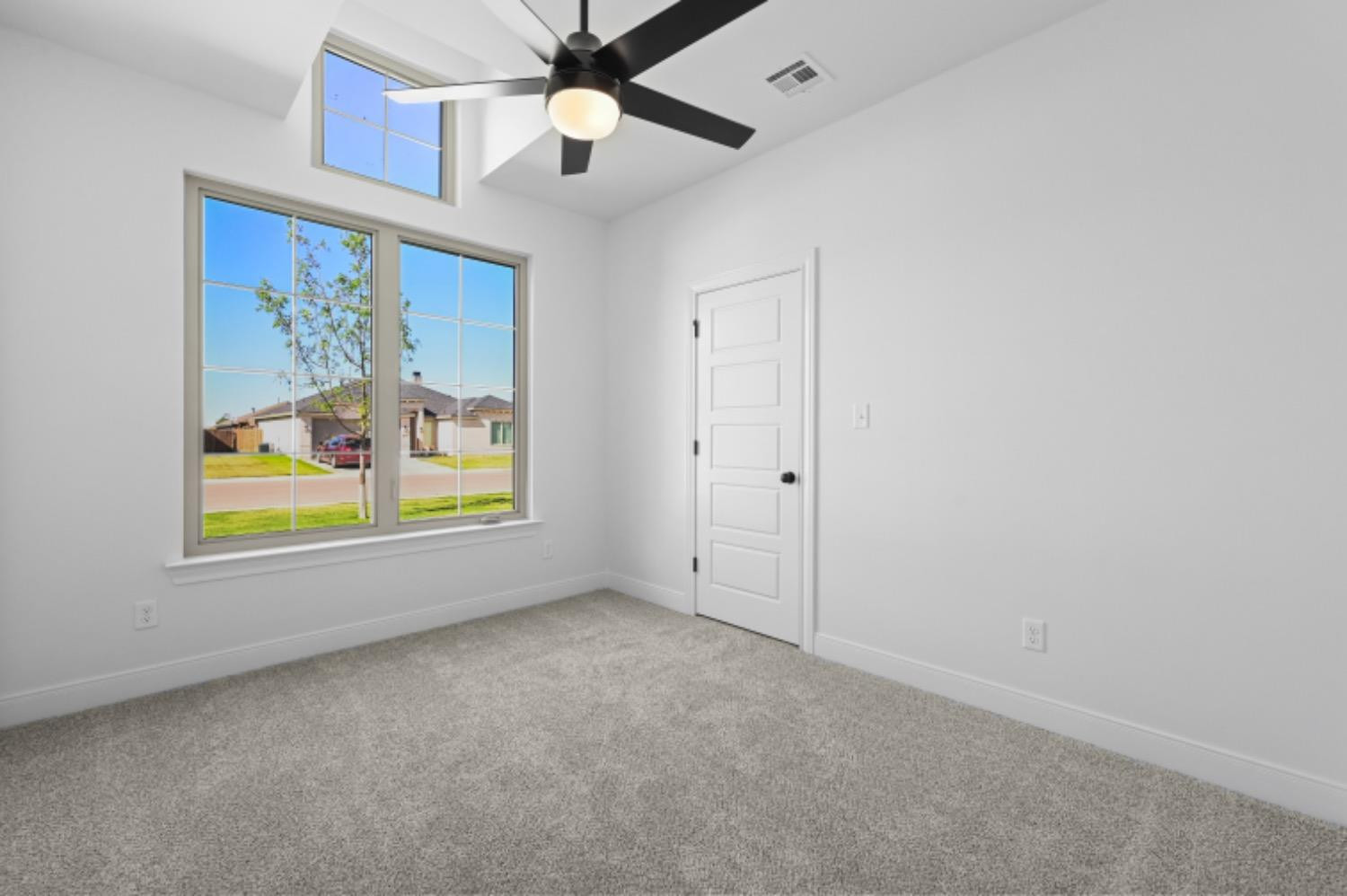 5607 119th Street Lubbock, TX 79424 - Photo 28 of 33 an empty room with windows and fan