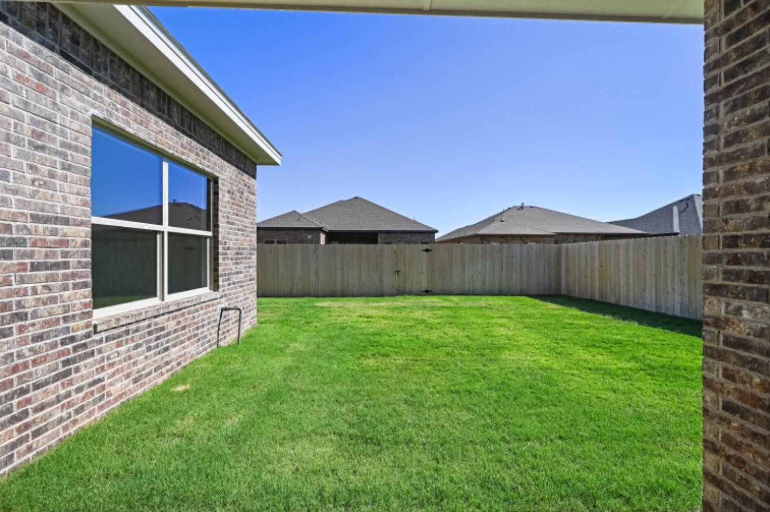 5607 119th Street Lubbock, TX 79424 - Photo 30 of 33 a view of a backyard with wooden fence