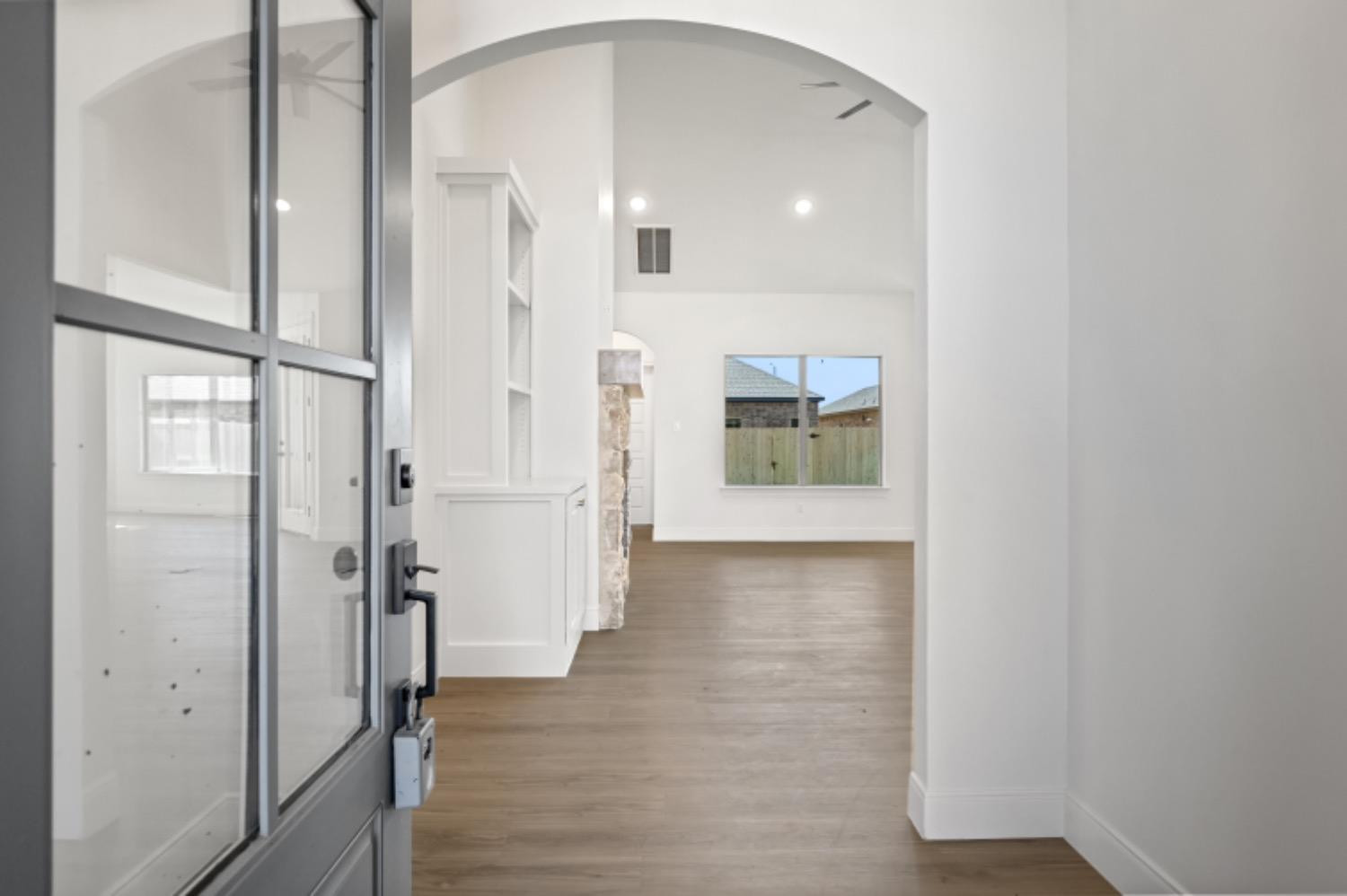 5607 119th Street Lubbock, TX 79424 - Photo 3 of 33 a view of a hallway with wooden floor and a bathroom