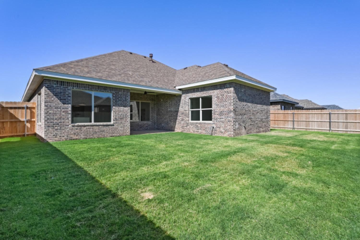 5607 119th Street Lubbock, TX 79424 - Photo 31 of 33 a front view of a house with a garden