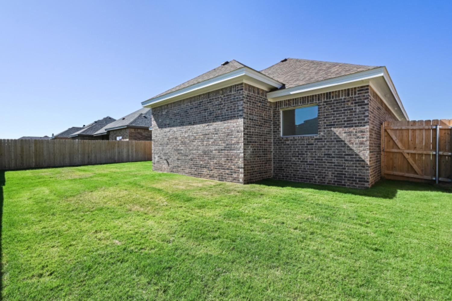 5607 119th Street Lubbock, TX 79424 - Photo 32 of 33 a front view of a house with a garden