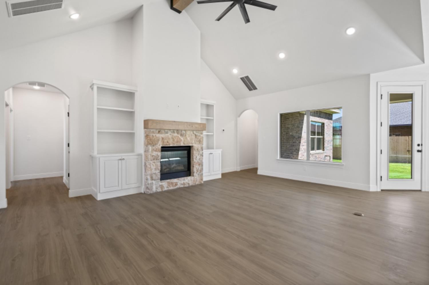 5607 119th Street Lubbock, TX 79424 - Photo 5 of 33 an empty room with windows and fireplace