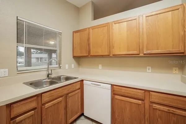 a kitchen with stainless steel appliances granite countertop white cabinets and sink