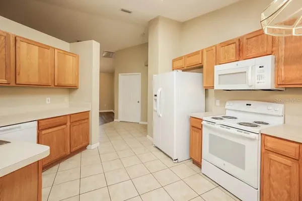 a kitchen with a stove a sink and a refrigerator