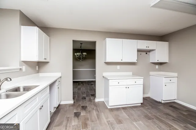 a kitchen with a stove a sink and a refrigerator
