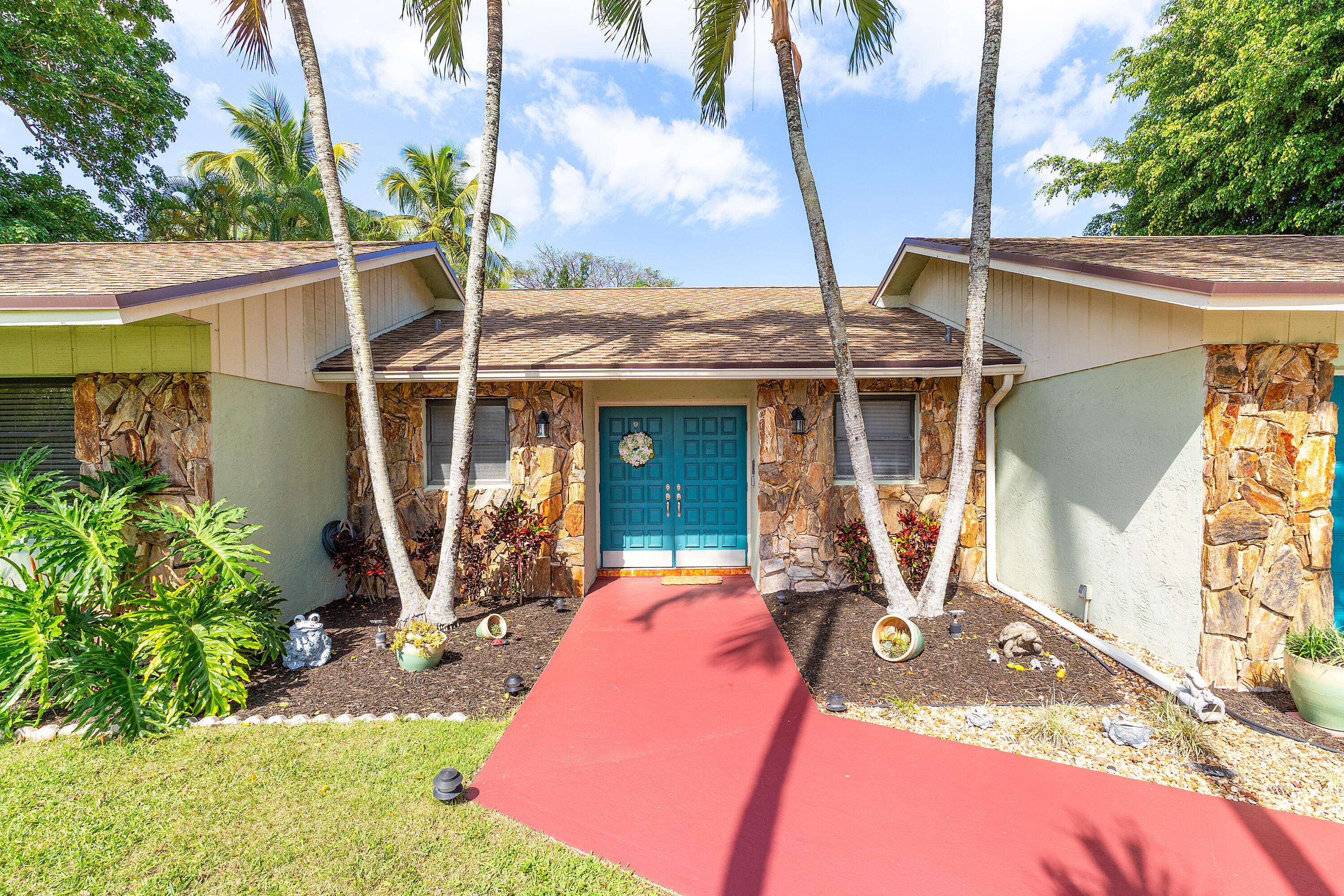 267 Old Country Road South Wellington, FL 33414 - Photo 1 of 22 a front view of a house with a patio