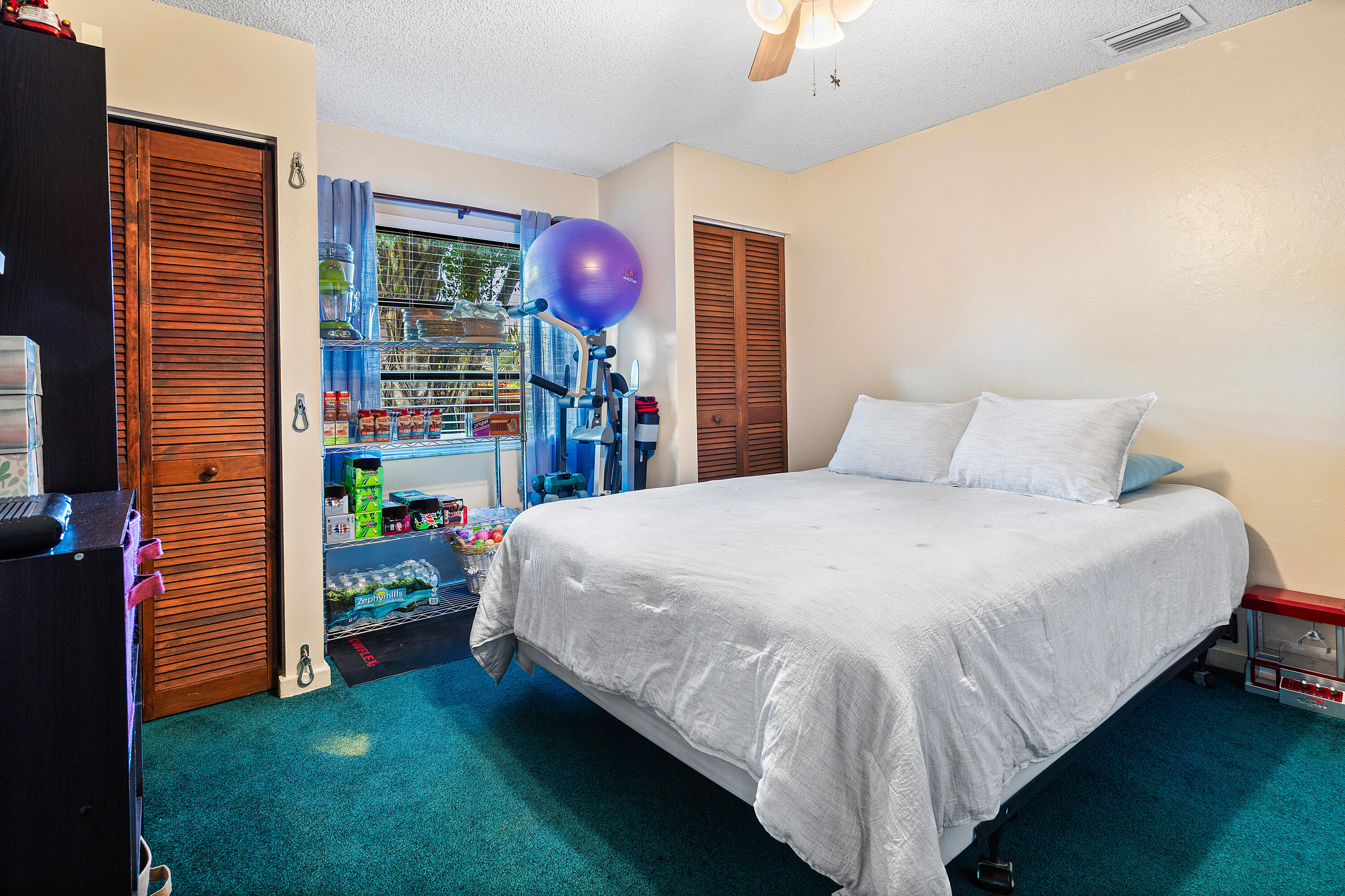 267 Old Country Road South Wellington, FL 33414 - Photo 12 of 22 a bed sitting in a bedroom next to a window and a lamp