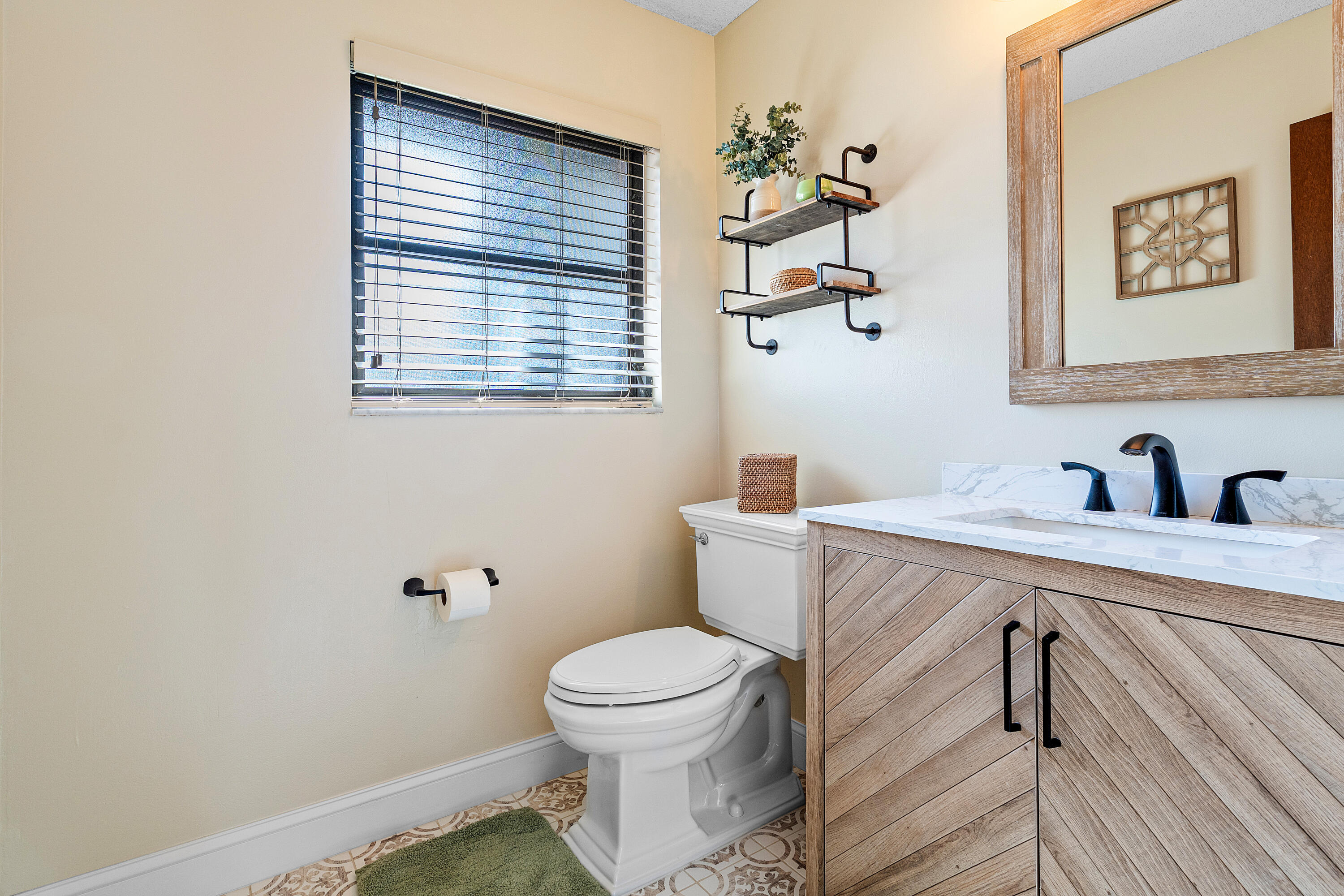 267 Old Country Road South Wellington, FL 33414 - Photo 15 of 22 a bathroom with a toilet a sink and mirror