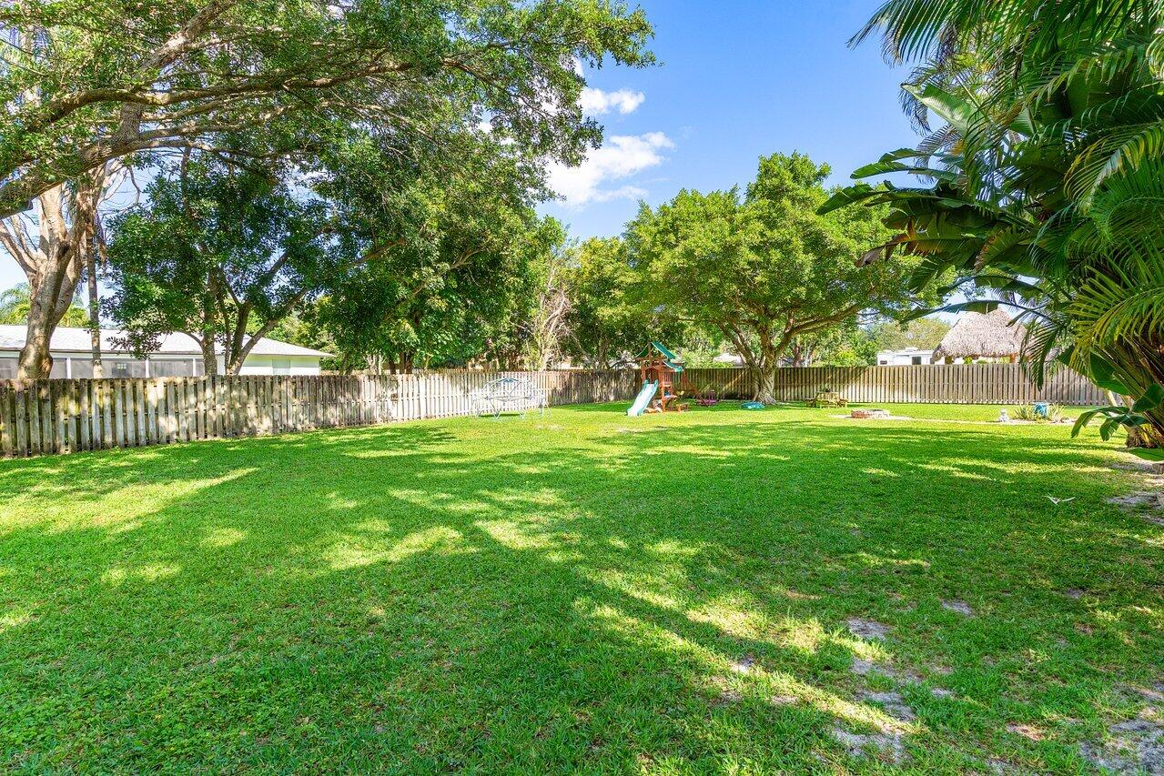 267 Old Country Road South Wellington, FL 33414 - Photo 21 of 22 a view of green field with trees in the background