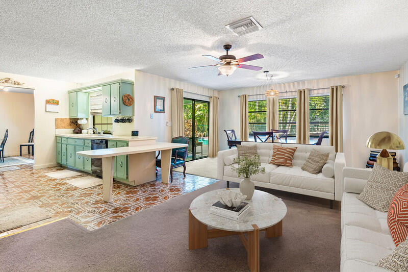 267 Old Country Road South Wellington, FL 33414 - Photo 5 of 22 a living room with furniture chandelier and a large window