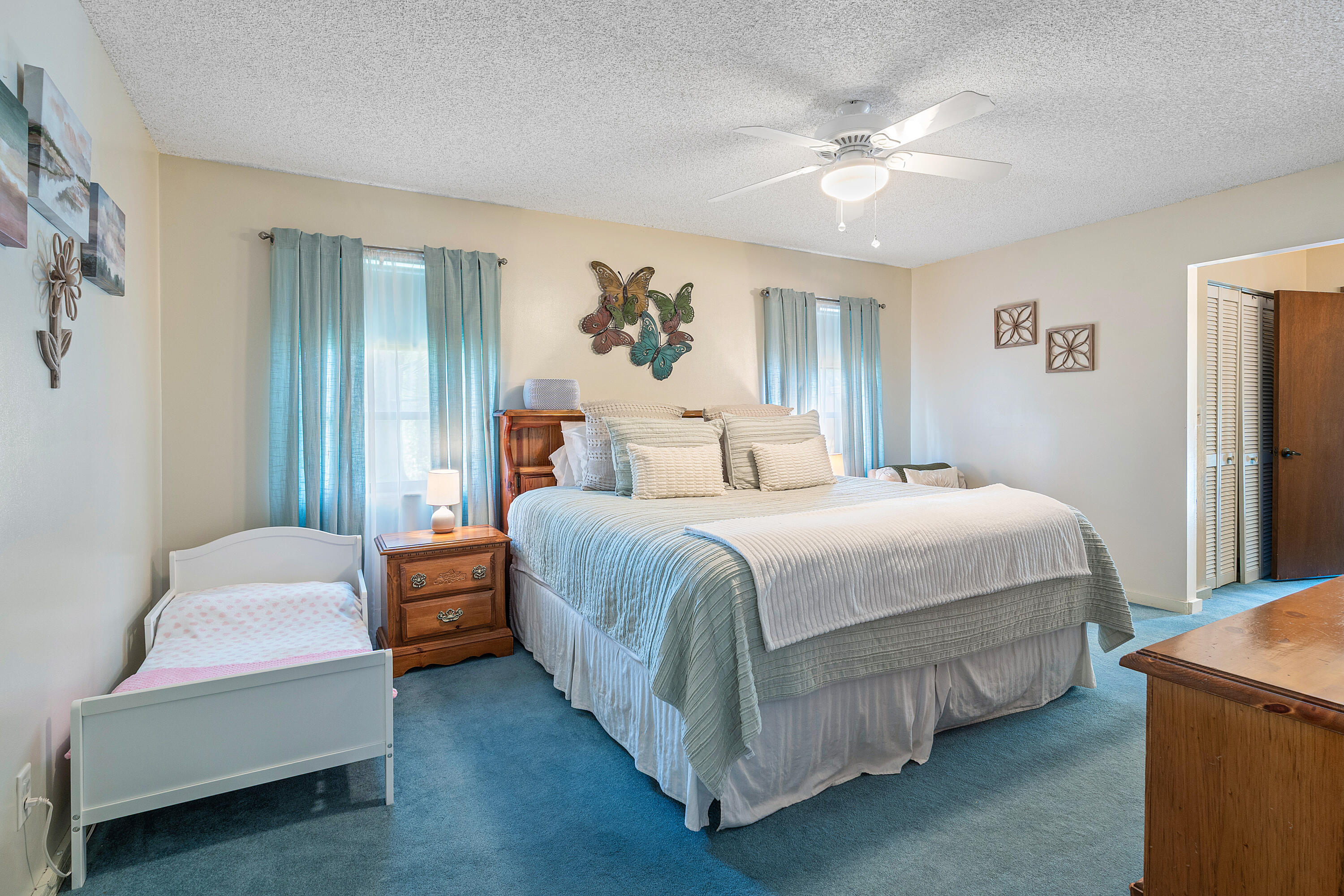 267 Old Country Road South Wellington, FL 33414 - Photo 9 of 22 a spacious bedroom with a bed and a chandelier