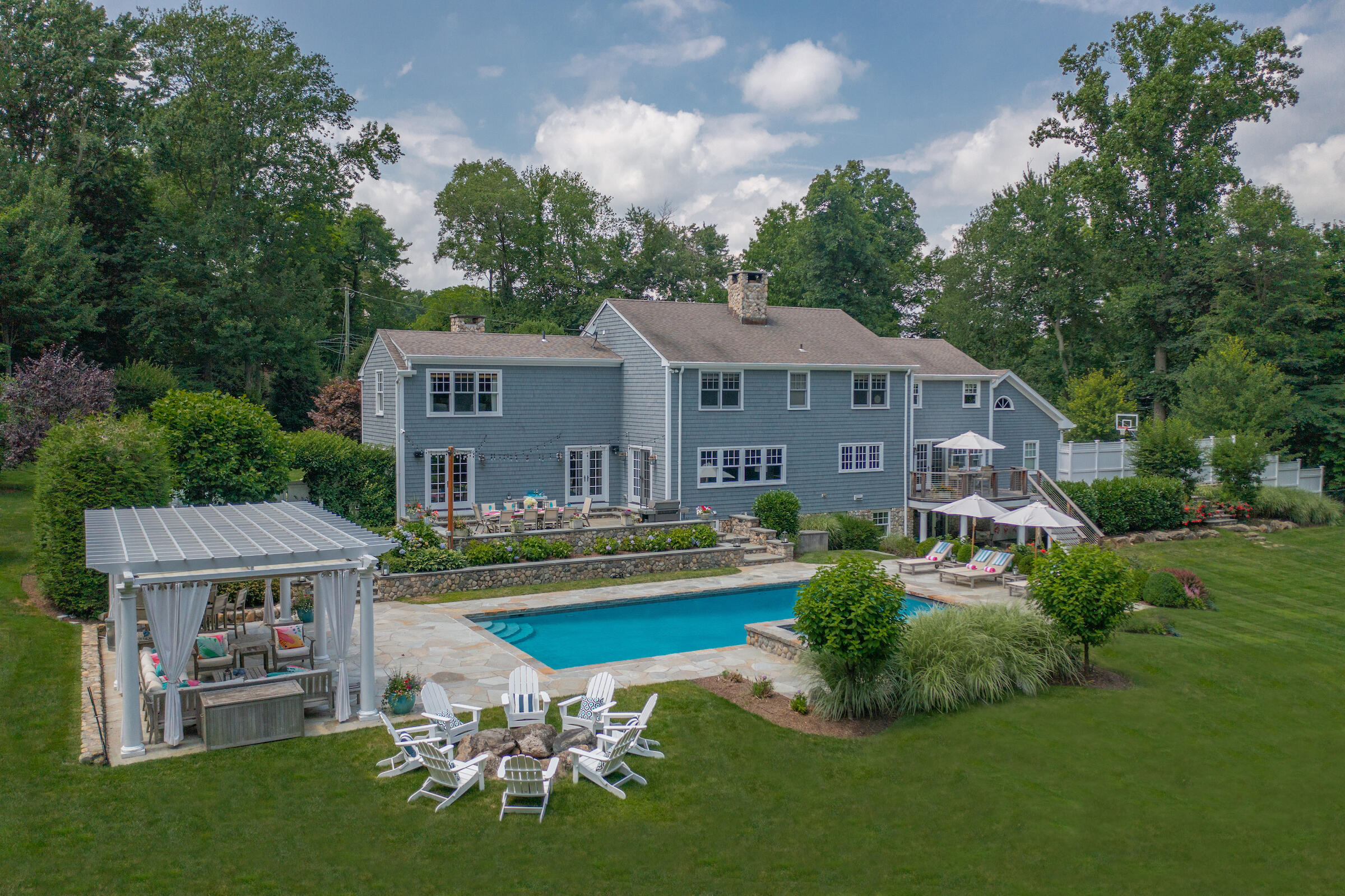 8 Hanson Road Darien, CT 06820 - Photo 30 of 38 a front view of a house with a yard table and chairs