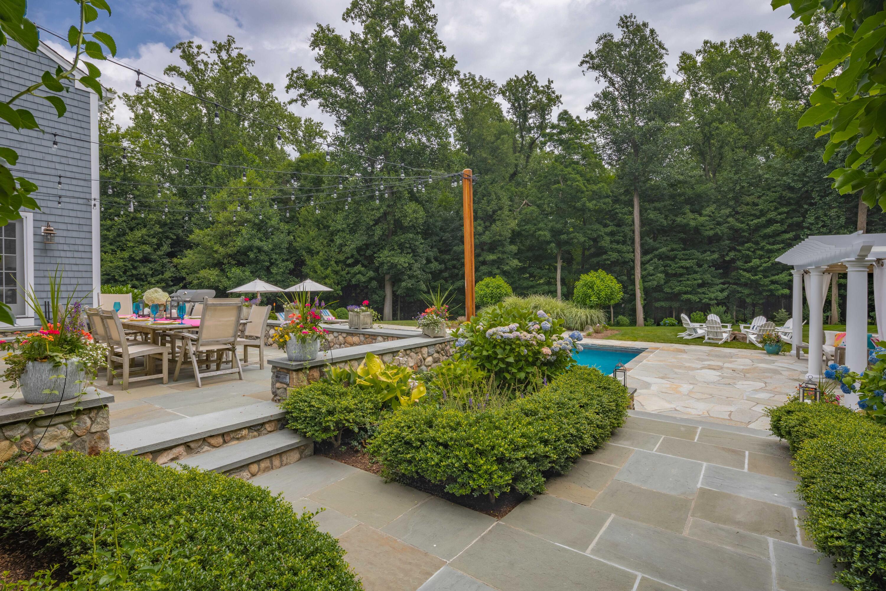 8 Hanson Road Darien, CT 06820 - Photo 32 of 38 a view of a chair and table in backyard of the house