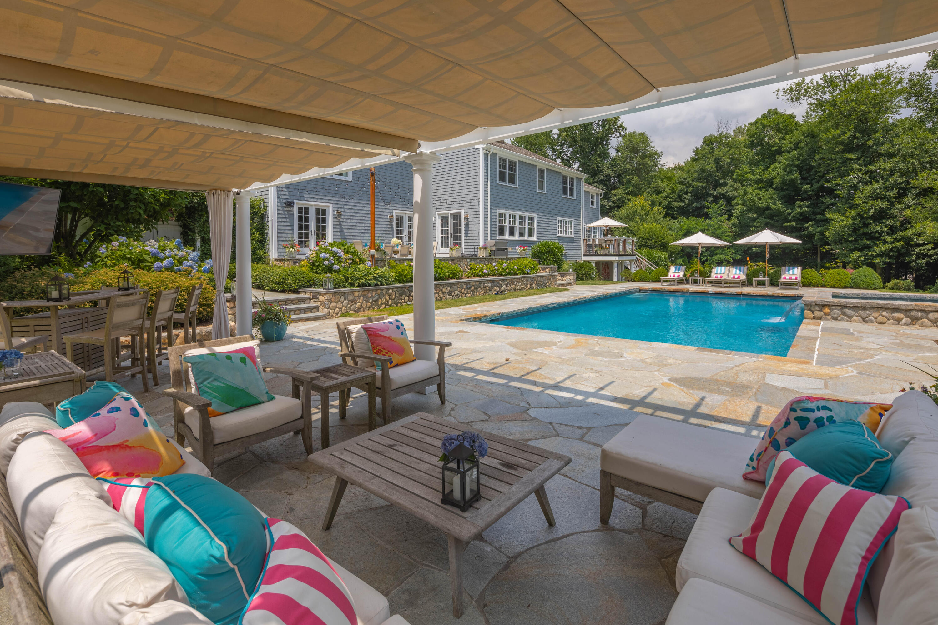 8 Hanson Road Darien, CT 06820 - Photo 34 of 38 a view of a patio with couches table and chairs under an umbrella
