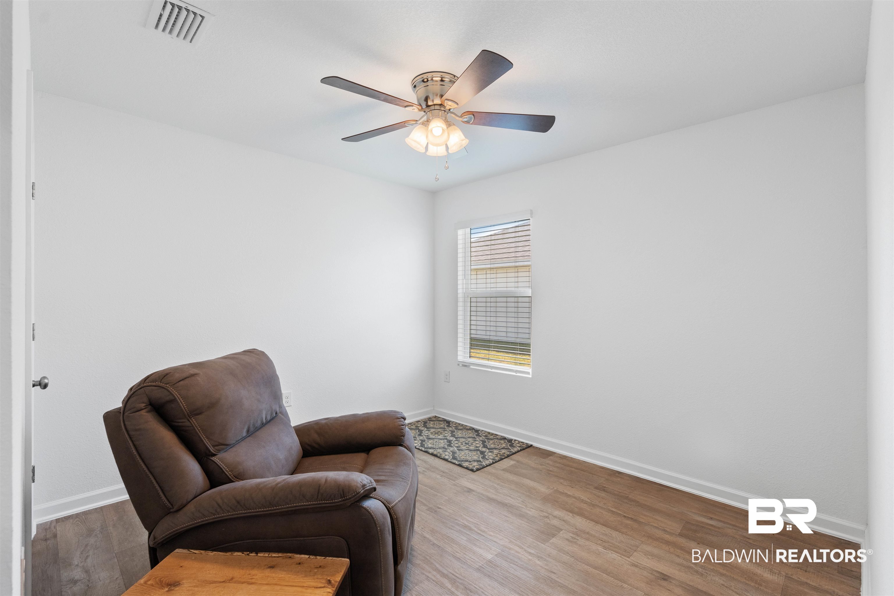 15030 Forsythia Loop Silverhill, AL 36576 - Photo 22 of 33 Living area with baseboards and wood finished floors