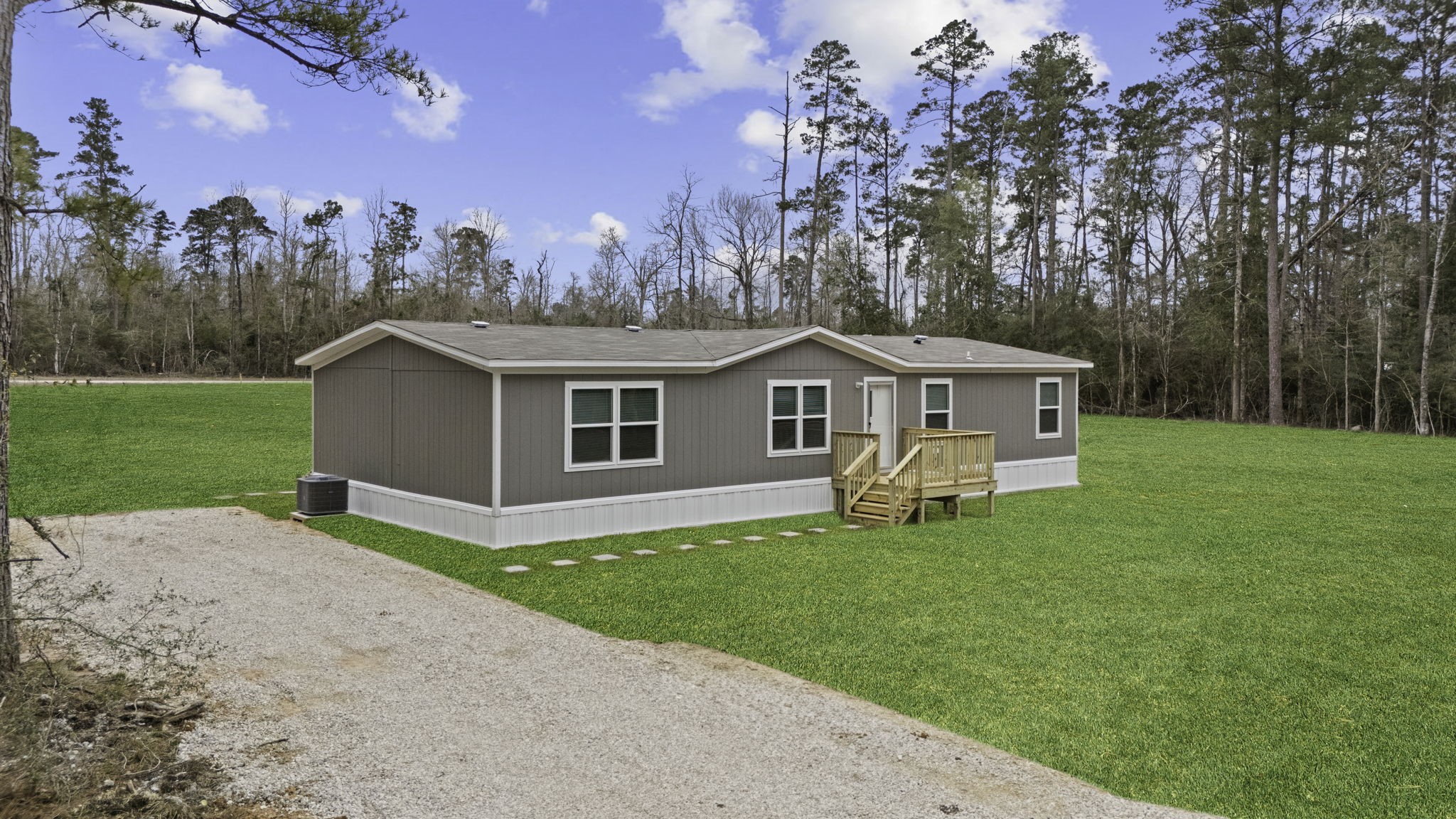 245 Rustic Way Livingston, TX 77351 - Photo 2 of 33 a front view of a house with a yard