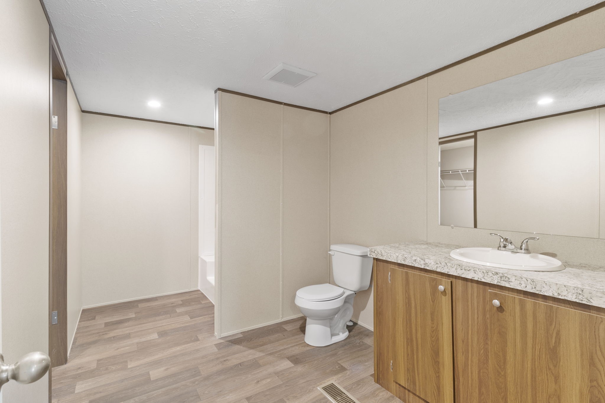 245 Rustic Way Livingston, TX 77351 - Photo 23 of 33 a bathroom with a granite countertop sink a toilet and a mirror
