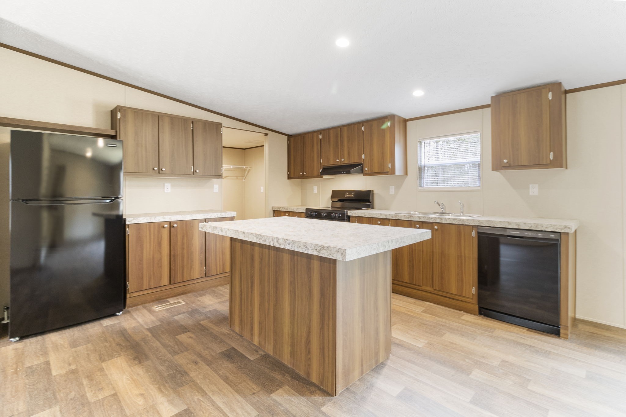 245 Rustic Way Livingston, TX 77351 - Photo 6 of 33 a kitchen with kitchen island a sink stainless steel appliances and cabinets