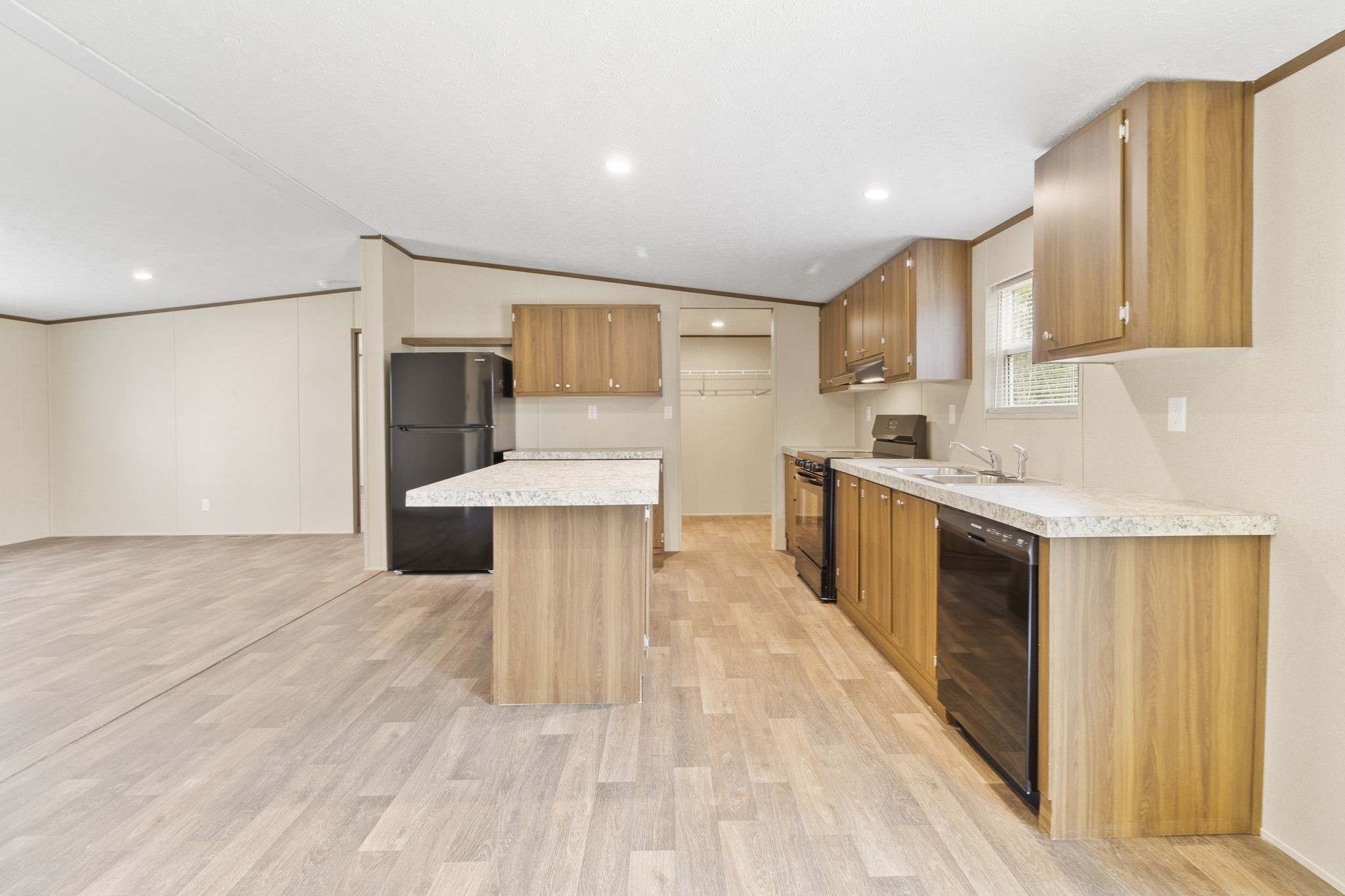 245 Rustic Way Livingston, TX 77351 - Photo 7 of 33 a large kitchen with stainless steel appliances a sink a stove a microwave a counter top space and cabinets